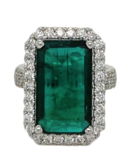 18Kt White Gold Halo Style Ring With An Emerald Cut Emerald Weighing 7.49ct And A Halo And Band Of 103 Round Diamonds Weighing 1.25ct