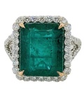[21338] 18Kt White Gold Halo Style Ring With An Octagonal Emerald Weighing 7.27ct And A Halo And Band Of 60 Round Diamonds Weighing 1.50ct