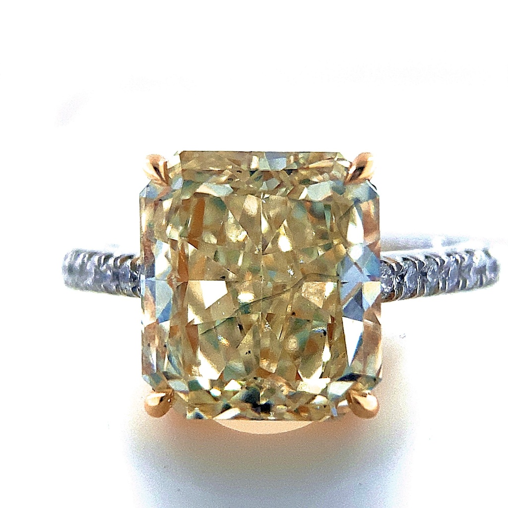 Platinum And 18Kt Yellow Gold Ring With A Radiant Cut Diamond Weighing 5.09ct And (20) Round Diamonds Weighing 0.23ct