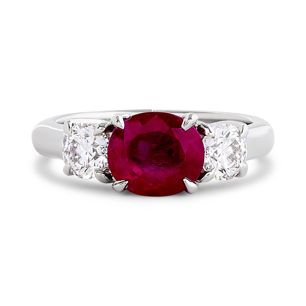 Platinum Three Stone Ring With An Oval Ruby Weighing 2.47ct And (2) Round Diamonds Weighing 0.80ct