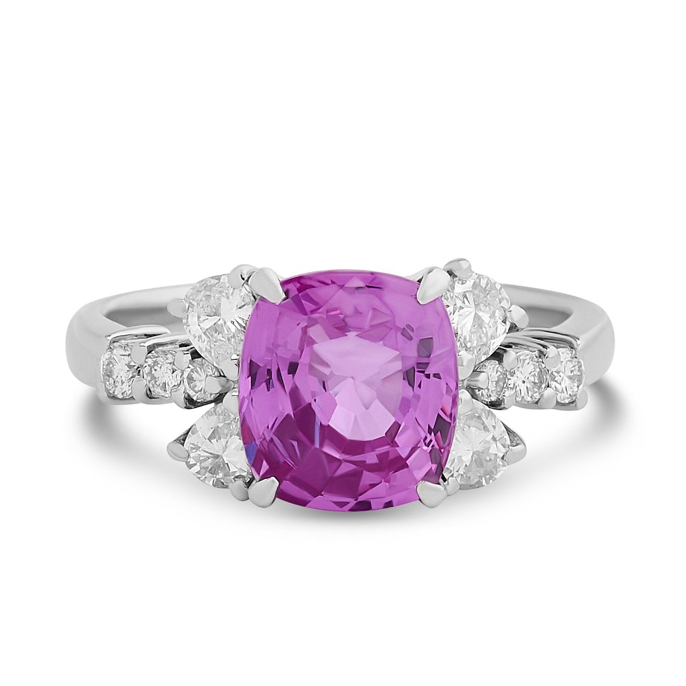 Platinum Ring With A Cushion Cut Pink Sapphire Weighing 3.84ct, And (4) Pear Shaped And (6) Round Diamonds Weighing 0.70ct