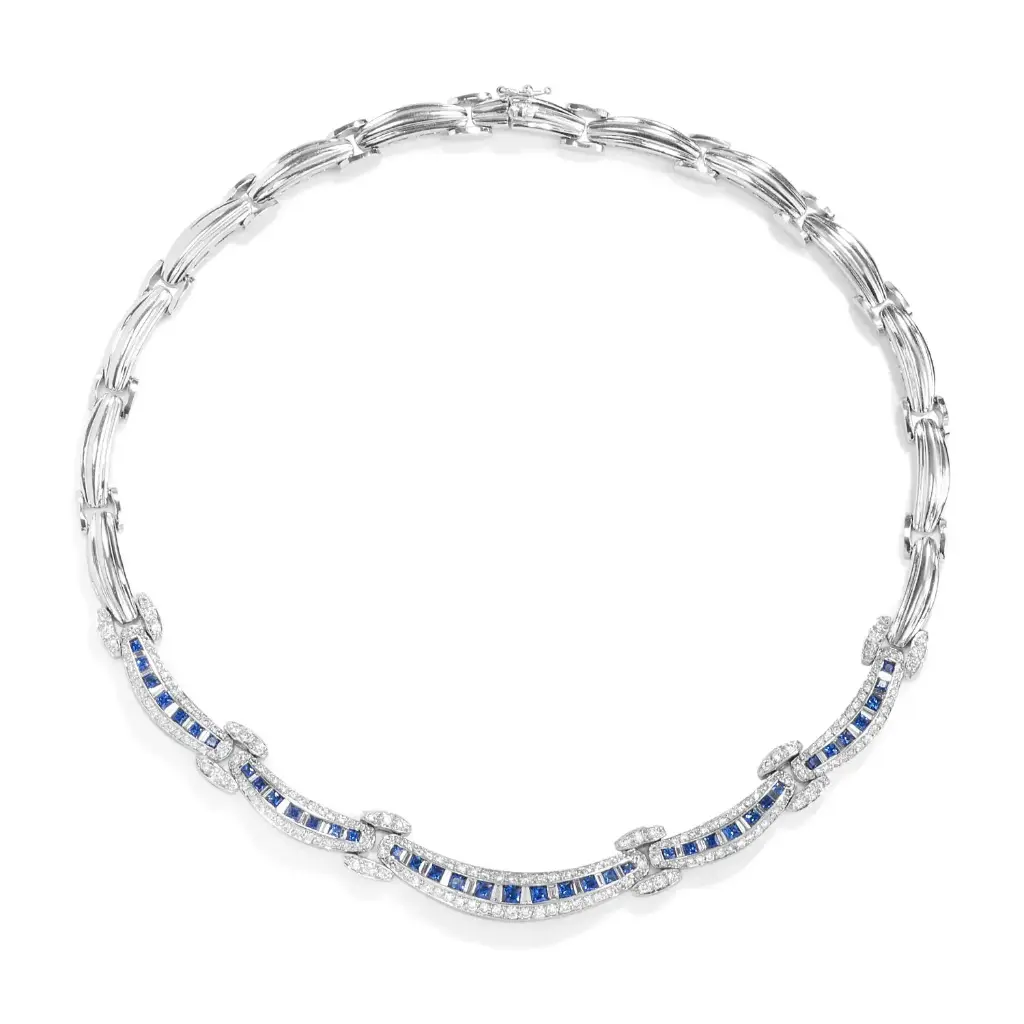 18Kt White Gold Necklace With (216) Round Diamonds Weighing 3.34ct, (34) Baguette Diamonds Weighing 1.15ct, And (39) Sapphires Weighing 3.62ct