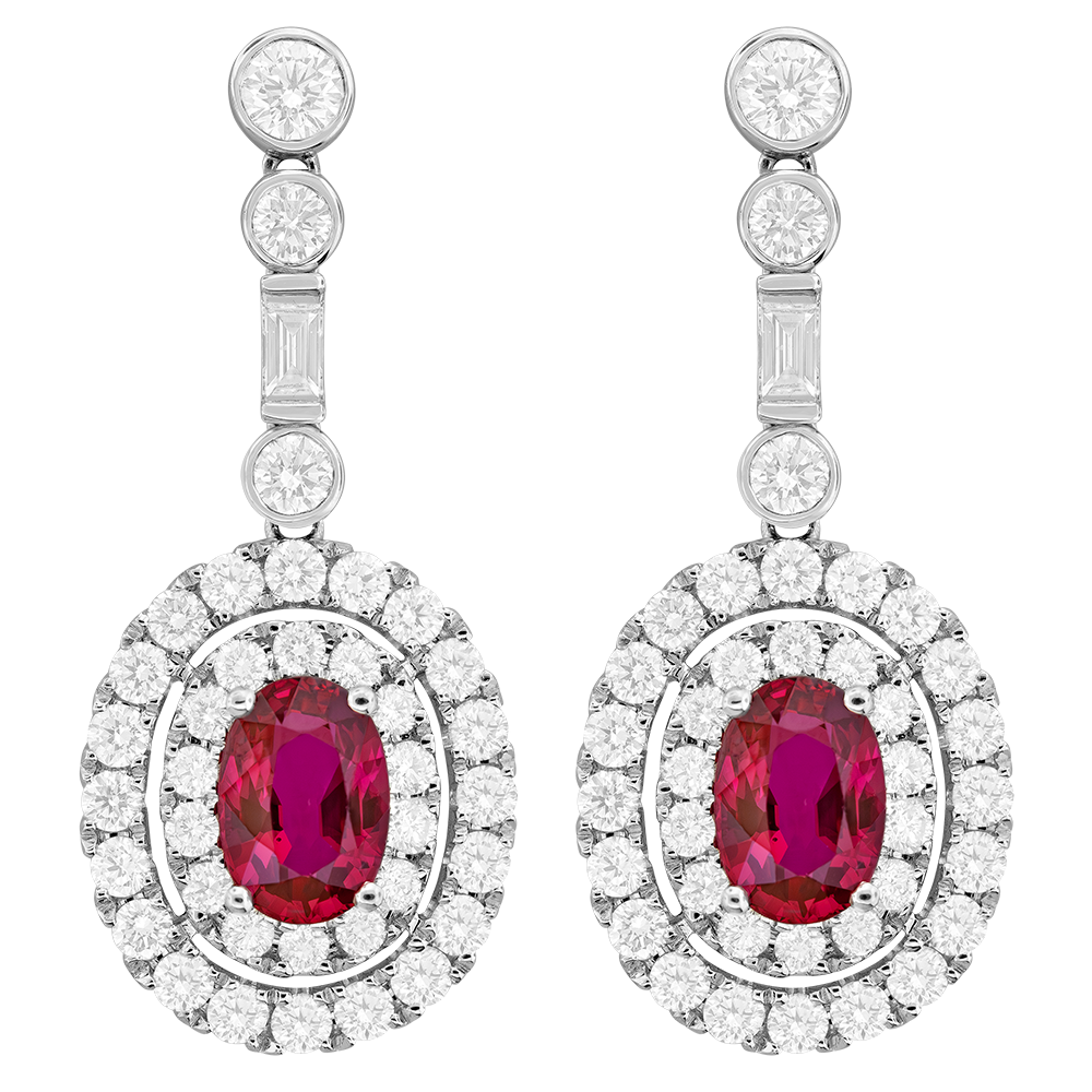 Halo Style Drop Earrings With (2) Oval Rubies Weighing 3.02ct, (74) Round And (2) Baguette Diamonds Weighing 2.78ct In 18Kt White Gold