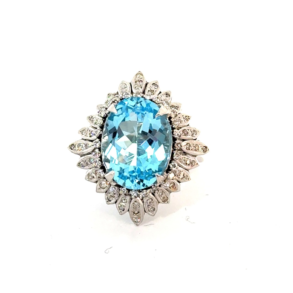 18Kt White Gold Halo Style Ring With A Blue Topaz Weighing 6.50ct and (73) Round Diamonds Weighing 0.35ct