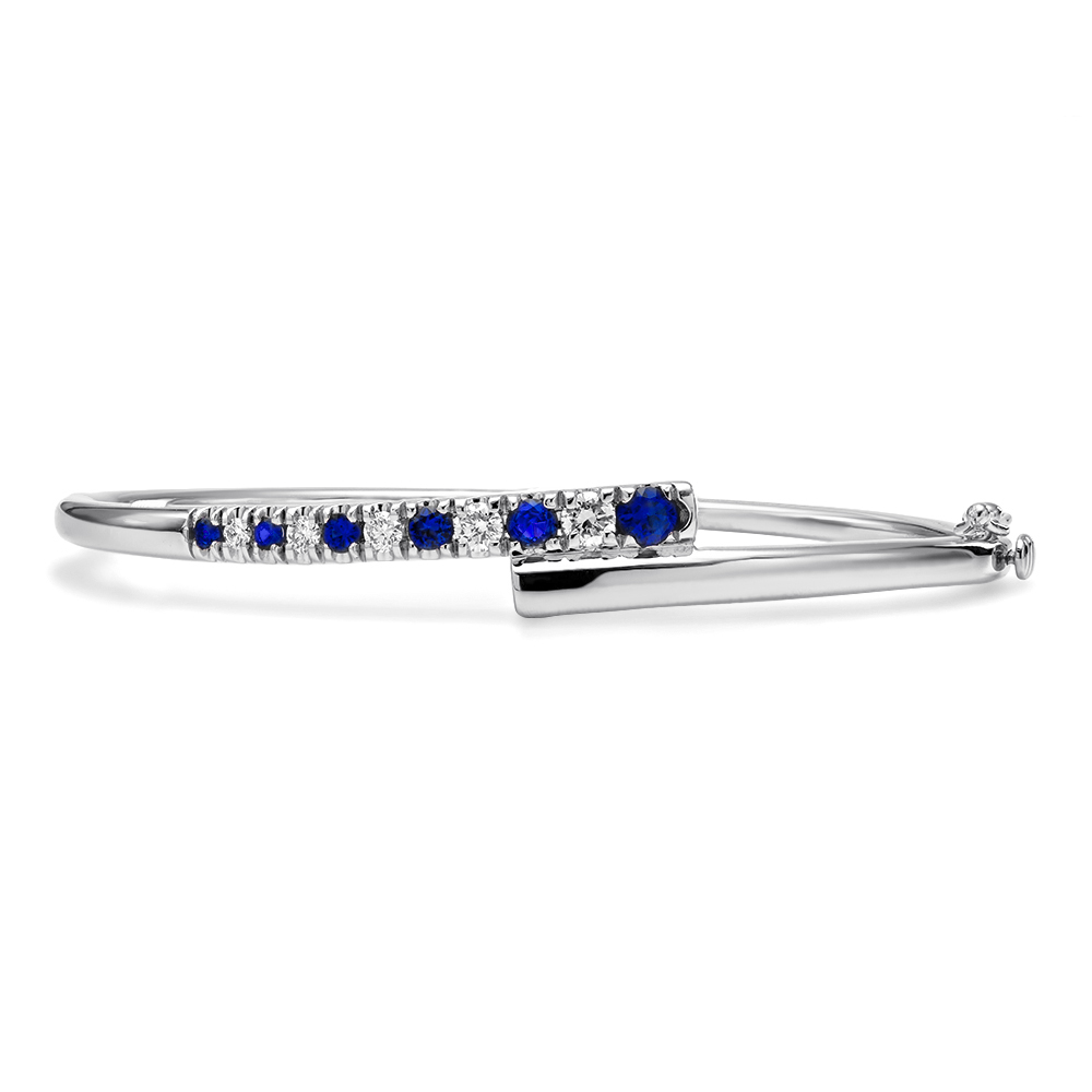 18Kt White Gold Coil Bangle With (6) Round Sapphires Weighing 0.58ct And (5) Round Diamonds Weighing 0.35ct