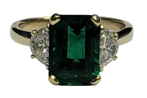 [22005] 18Kt Yellow Gold Three Stone Ring With an Emerald Cut Emerald Weighing 2.63ct And (2) Half Moon Diamonds Weighing 0.71ct