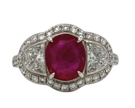 Platinum Ring With And Oval Ruby Weighing 1.90ct, (2) Half Moon Diamonds, And (40) Round Diamonds Weighing 1.08ct
