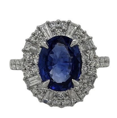 18Kt White Gold Halo Style Ring With An Oval Sapphire Weighing 3.50ct, (38) Round Diamonds Weighing 0.92, And (8) Baguette Diamonds Weighing 0.49ct