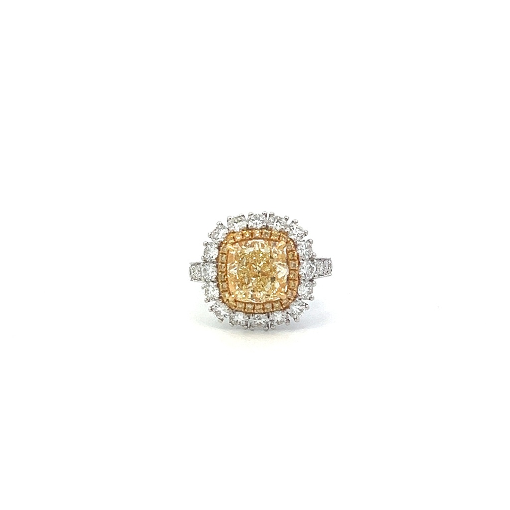 18Kt Two Toned Double Halo Ring With A Fancy Light Yellow Cushion Cut Diamond Weighing 3.10ct, (25) Round Yellow Diamonds Weighing 0.16ct, And (29) Round Diamonds Weighing 1.59ct