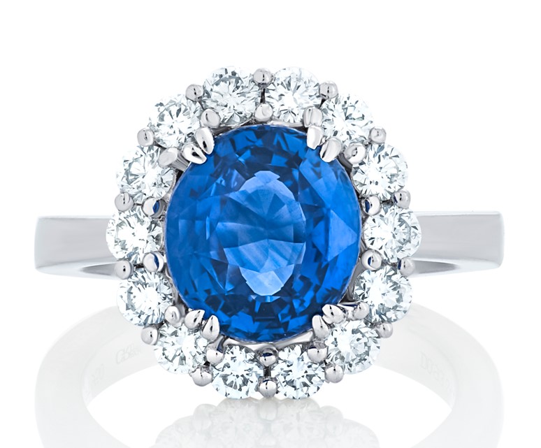 Platinum Halo Style Ring With An Oval Sapphire Weighing 4.12ct And (14) Round Diamonds Weighing 0.93ct