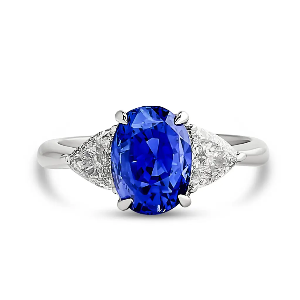 Three Stone Ring With An Oval Sapphire Weighing 3.43ct And (2) Trillion Cut Diamonds Weighing 0.79ct In Platinum