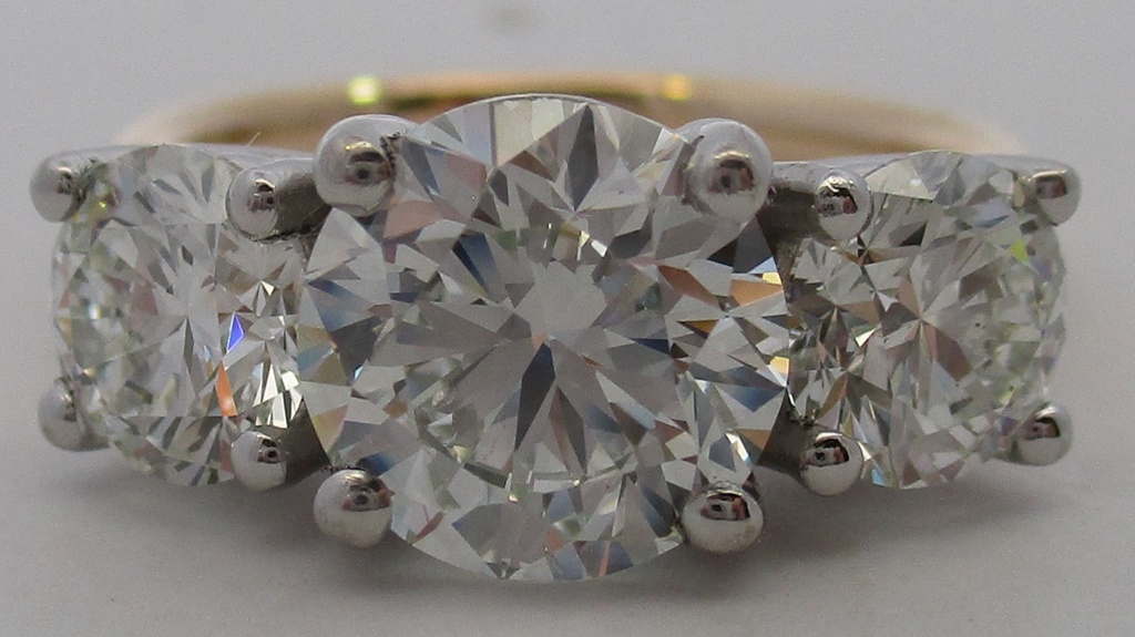 Platinum and 18Kt Yellow Gold Ring with A Round Diamond Weighing 2.00ct And (2) Round Diamonds Weighing 1.52cttw