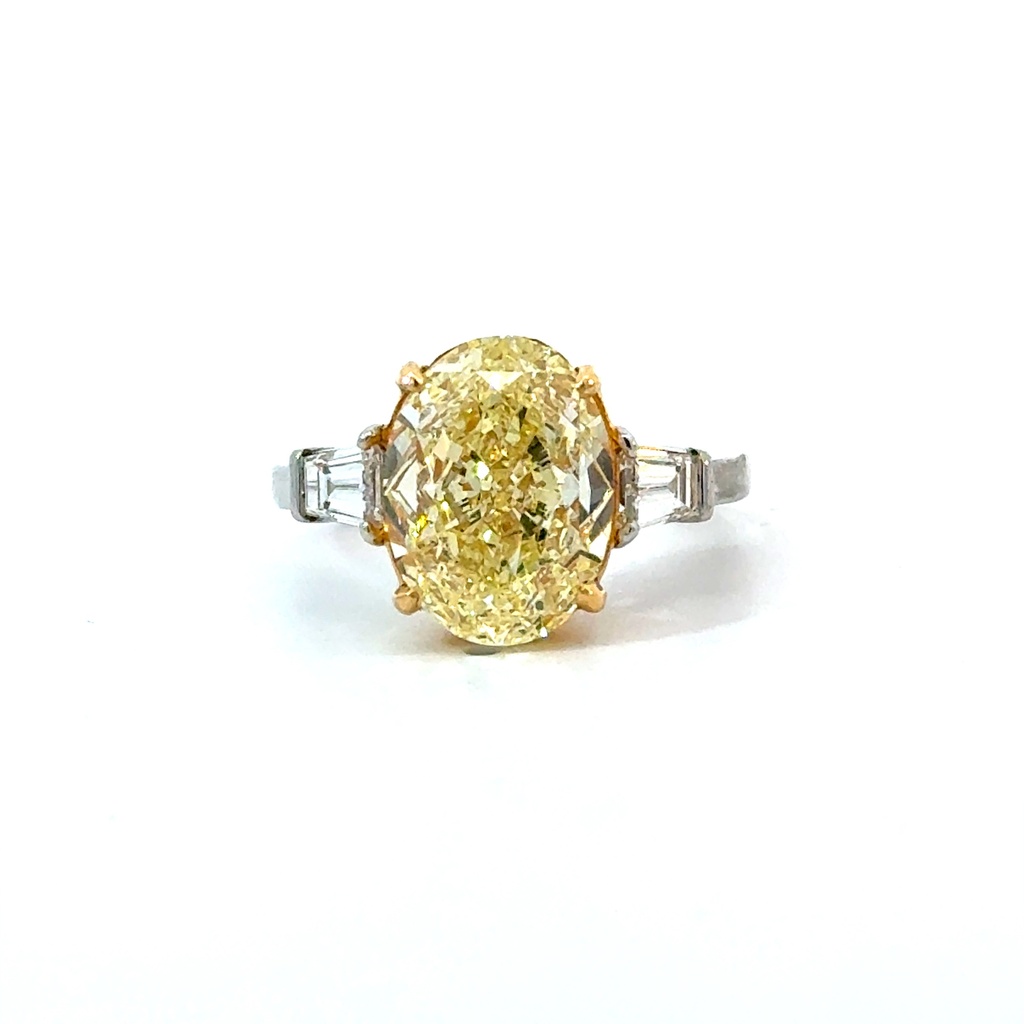 Platinum and 18Kt Yellow Gold Ring With An Oval Diamond Weighing 5.94ct FY/VS2 And (2) Baguette Diamonds Weighing 0.68ct