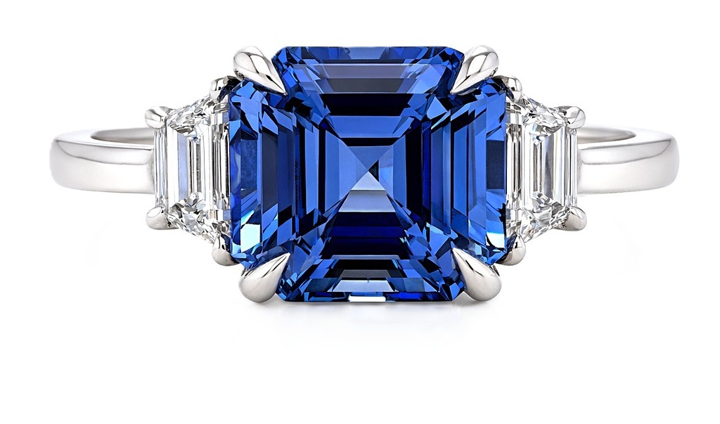 [24577] Platinum Ring With A Emerald Cut Sapphire Weighing 5.51ct And (2) Trapezoid Diamonds Weighing 0.53ct