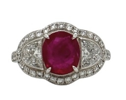 [22244] Platinum Ring With And Oval Ruby Weighing 1.90ct, (2) Half Moon Diamonds, And (40) Round Diamonds Weighing 1.08ct