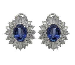 [21288] Platinum Halo Style Studs With (2) Oval Sapphires Weighing 6.66ct. (36) Round Diamonds Weighing 3.15ct, And (20) Baguette Diamonds Weighing 2.35ct