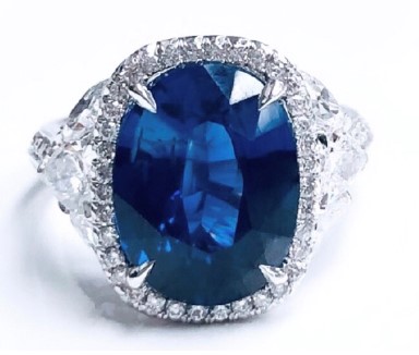 [15436] Platinum Ring With An Oval Sapphire Weighing 6.07ct, (92) Round Diamonds Weighing 0.65ct, (4) Marquise Diamonds Weighing 1.20ct, And (2) Pear Shaped Diamonds Weighing 0.65ct