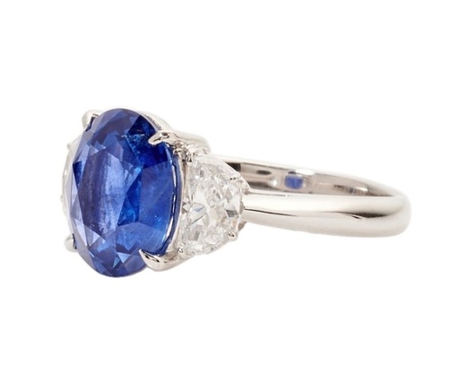 [R77800.2] Platinum Three Stone Ring With An Oval Sapphire Weighing 3.89ct And (2) Half Moon Diamonds Weighing 0.73ct