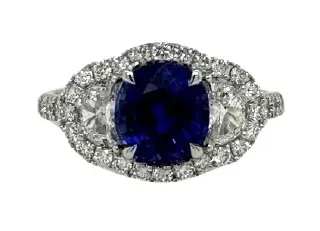 [22224] 18Kt White Gold Ring With A Cushion Cut Sapphire Weighing 2.46ct, (2) Half Moon Diamonds Weighing 0.47ct, And (36) Round Diamonds Weighing 0.55cttw