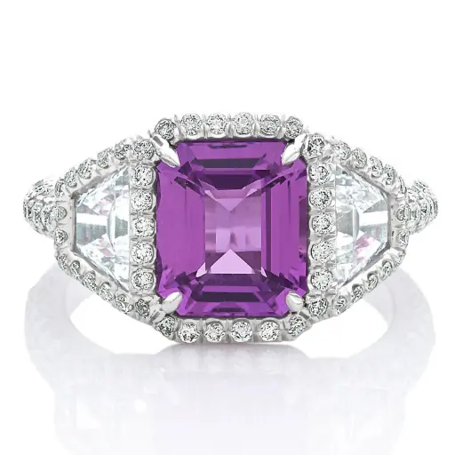 [R70978] Three Stone Style Halo Ring With A Pink/Purple Sapphire Weighing 3.00ct, (2) Trapezoid Diamonds Weighing 1.30ct, And (118) Round Diamonds Weighing 1.00ct In Platinum